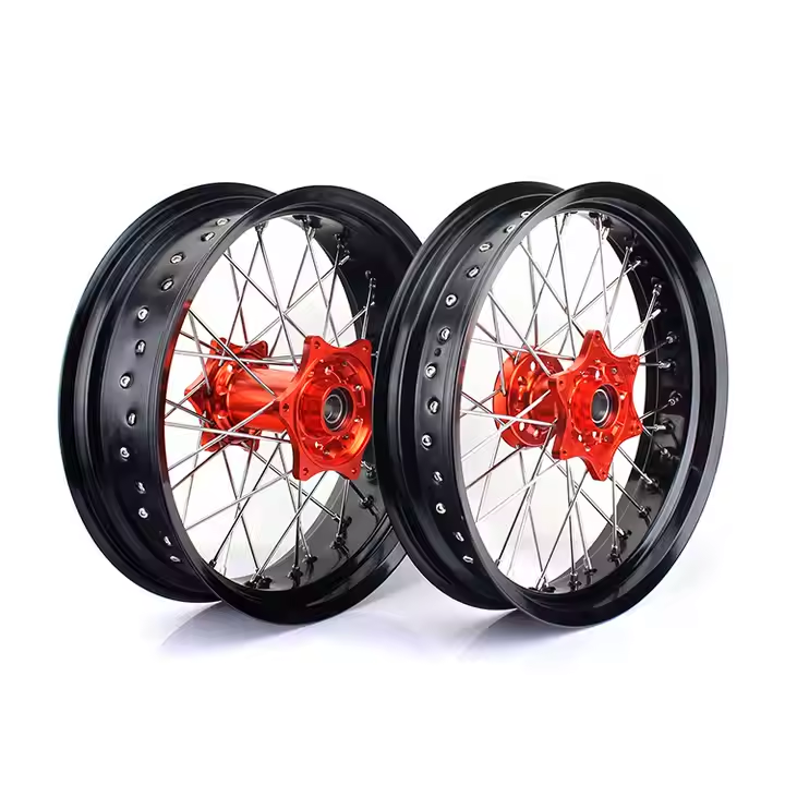 Red anodized CNC hub laced motorcycle wheels with black rims, designed for Suzuki off-road or street tracker applications.