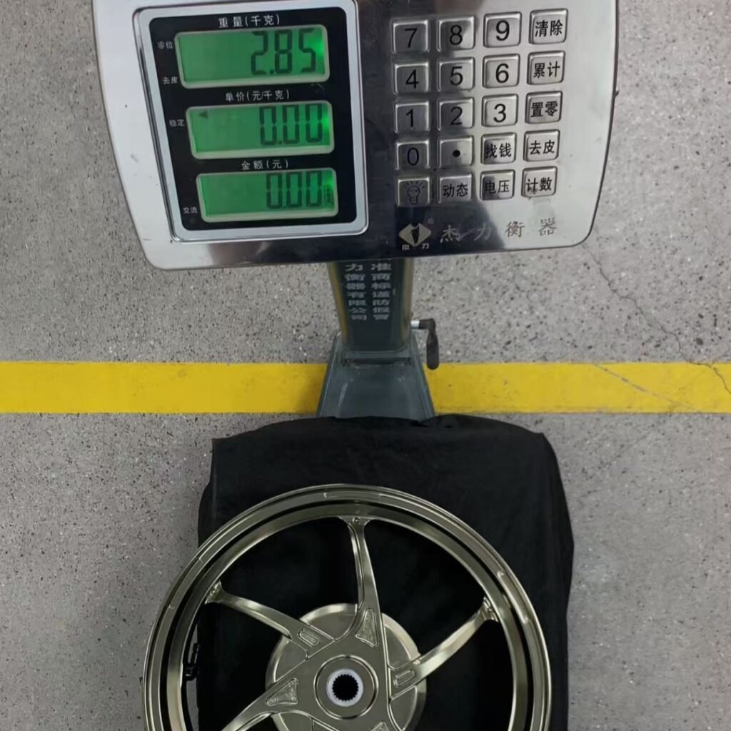 Gold anodized rear wheel for Yamaha NVX155 displayed on digital scale showing 2.85kg