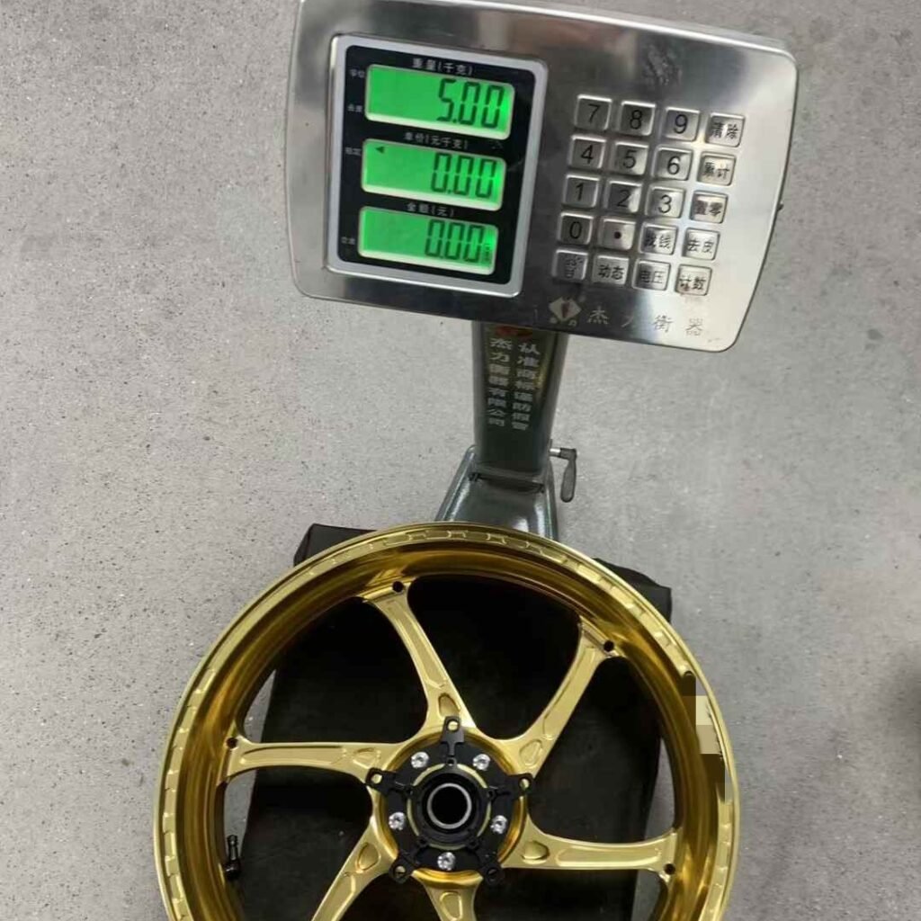 Gold forged monoblock rear wheel on weight scale for Yamaha R1