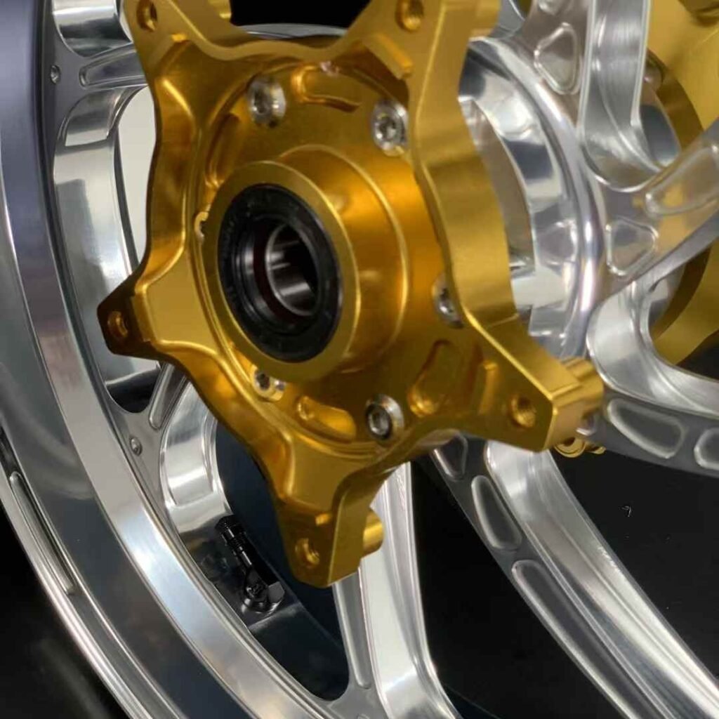 CNC-machined gold hub with pre-installed bearing on forged Yamaha TMAX 560 wheel