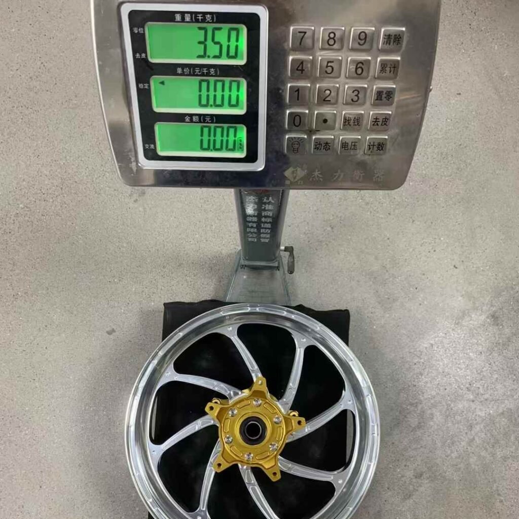 Yamaha TMAX 560 forged front wheel shown on electronic scale with 3.5kg reading