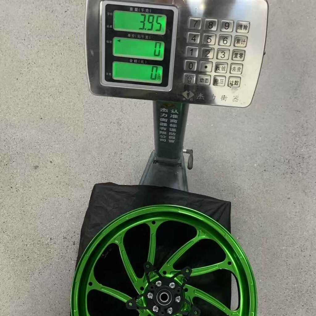 Yamaha XMAX 300 rear wheel in green anodized finish on scale with 3.95kg reading