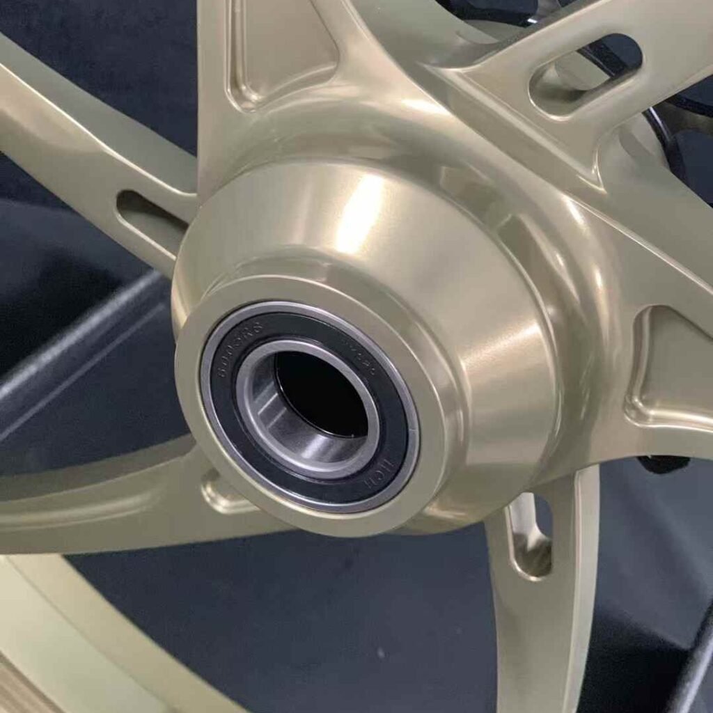 Close-up of titanium anodized front hub with integrated bearing for Yamaha R3