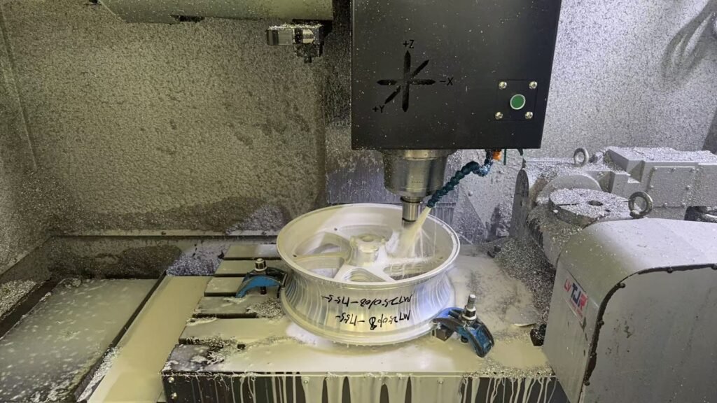 CNC machining process shaping a forged motorcycle wheel hub and spoke design