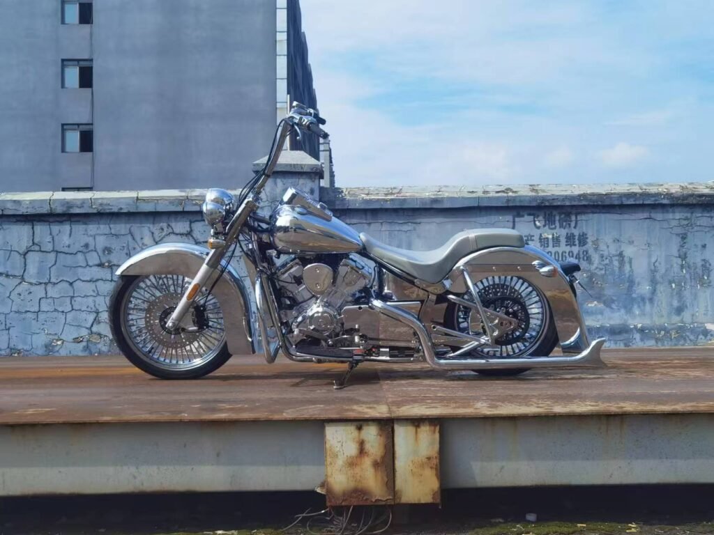 Silver custom chopper motorcycle build with chrome finish, ape hanger handlebars and spoke wheels in full side view