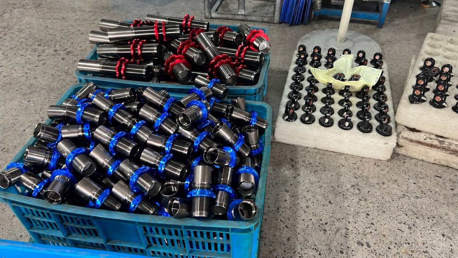 Threaded motorcycle rear shock absorber bodies with red and blue anodized preload collars and black eyelets